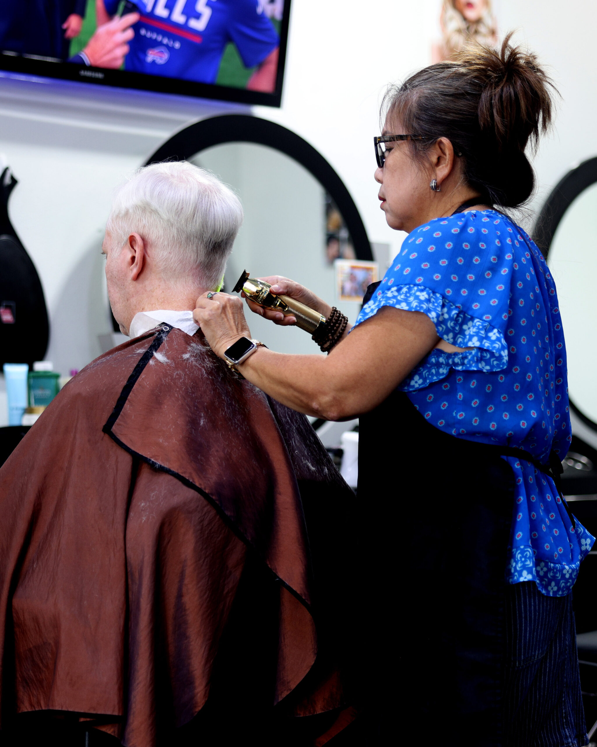 Hair stylist working with a client